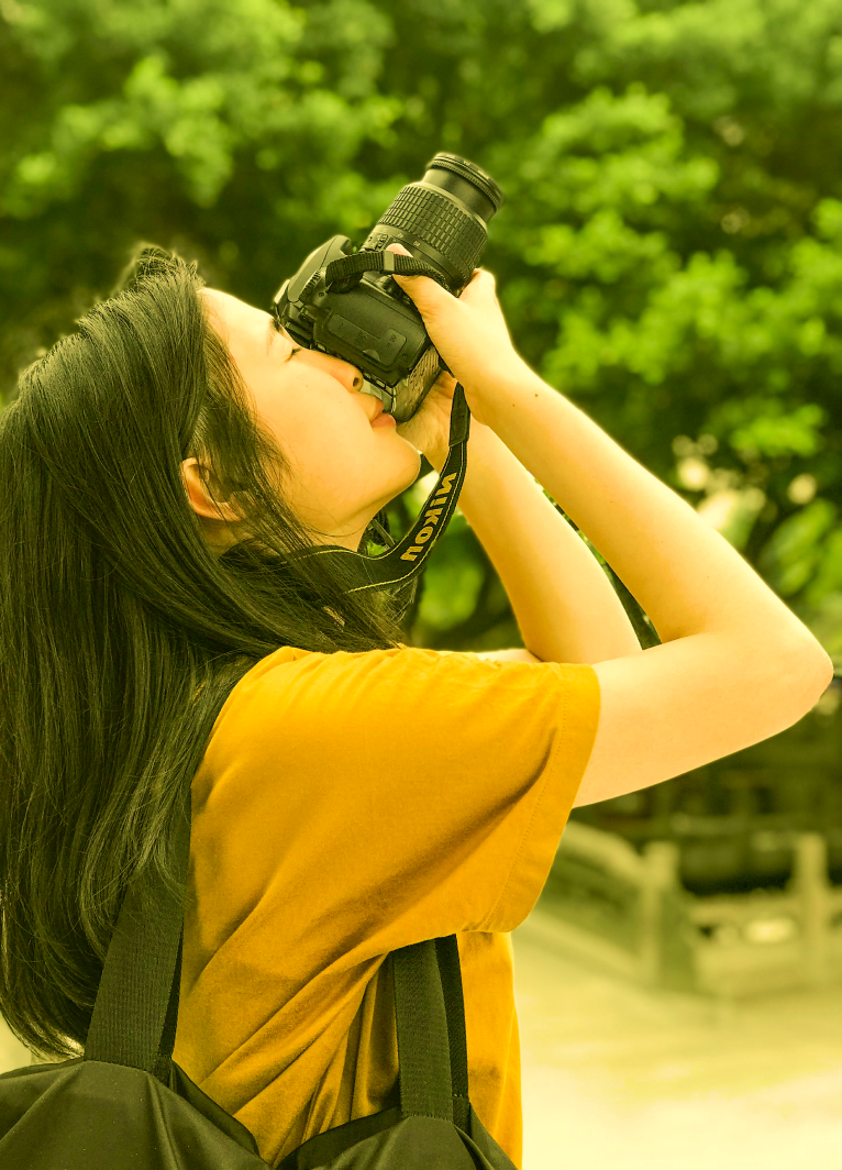 woman taking a photo outdoors