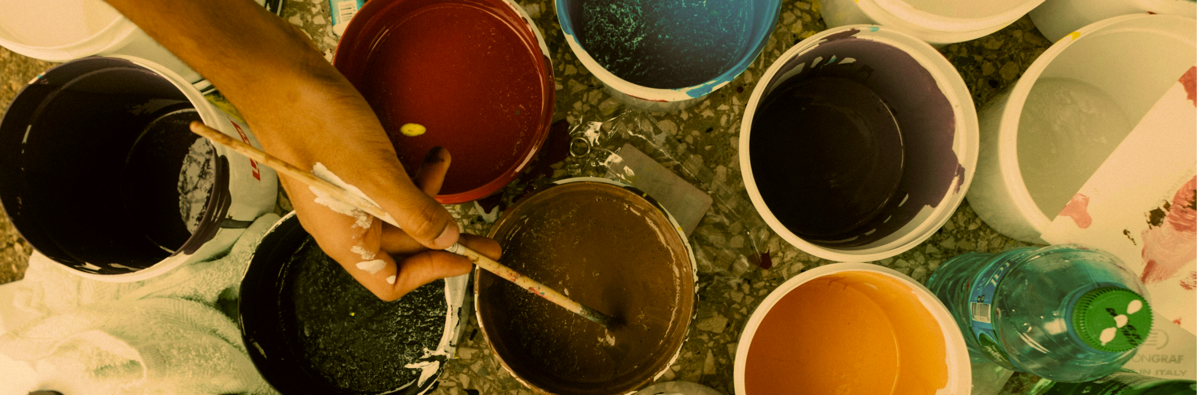 paintbrush with cups of paint